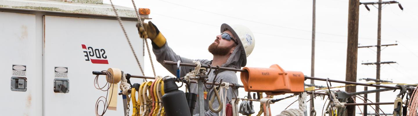 Technician working on an electrical pole